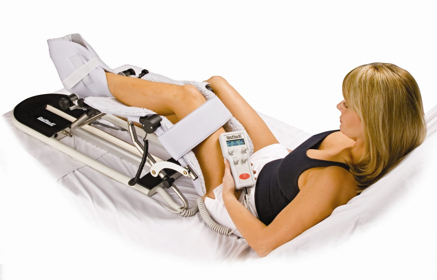 Woman using a CPM machine on her knee.