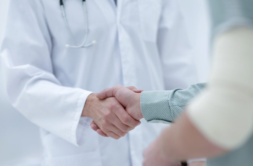 Doctor and patient shaking hands.
